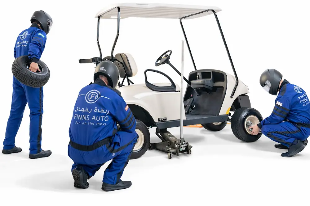 Finns Auto technician team servicing an electric golf cart